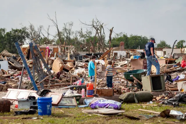 A Family Surveys the Damage from a Tornado